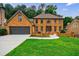 Charming brick home with a well-manicured lawn and a two-car garage at 5826 Andover Way, Tucker, GA 30084