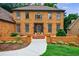 Close up view of the home's brick facade, well-kept landscaping, and decorative front door at 5826 Andover Way, Tucker, GA 30084