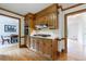 Well-appointed kitchen with wood cabinets, stone countertops, and open access to other living spaces at 5826 Andover Way, Tucker, GA 30084