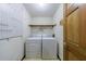 Functional laundry room with washer, dryer, and overhead storage, providing convenience and organization at 5826 Andover Way, Tucker, GA 30084