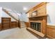 Cozy living room featuring a brick fireplace, wood trim, built-in shelving, and carpeted staircase at 5826 Andover Way, Tucker, GA 30084
