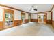Spacious living room featuring bright lighting, wood trim windows and doors, and carpeted floors at 5826 Andover Way, Tucker, GA 30084