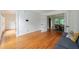 Open living room featuring hardwood floors, white walls, and French doors leading to dining area at 5826 Andover Way, Tucker, GA 30084