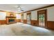 Spacious living room featuring a brick fireplace, carpet flooring, and a ceiling fan at 5826 Andover Way, Tucker, GA 30084