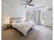 Spacious main bedroom featuring a ceiling fan, carpeted floors, and two windows with tree views at 5826 Andover Way, Tucker, GA 30084