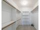 Walk-in closet with multiple shelves and clothing rods for optimal wardrobe storage at 5826 Andover Way, Tucker, GA 30084