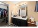 Well-maintained bathroom with a sink, large mirror, and a storage cabinet at 7030 Kingston Ln, Mcdonough, GA 30253