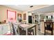 Charming dining area with neutral tones, hardwood floors, and a clear view into the living area at 7030 Kingston Ln, Mcdonough, GA 30253