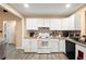 Bright kitchen with white cabinets, granite counters, and a mosaic backsplash for a modern touch at 7030 Kingston Ln, Mcdonough, GA 30253