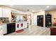 Well-lit kitchen with white cabinetry, granite countertops, stainless steel appliances, and hardwood floors at 7030 Kingston Ln, Mcdonough, GA 30253