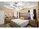 Bright main bedroom with a tray ceiling, modern decor, and dark curtains for an inviting retreat at 7030 Kingston Ln, Mcdonough, GA 30253