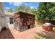 Brick patio featuring a screened gazebo with lush greenery, ideal for outdoor gatherings and relaxation at 7030 Kingston Ln, Mcdonough, GA 30253