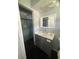 Bathroom with tiled shower, gray vanity with modern faucet, and sleek design at 763 N Hairston Rd, Stone Mountain, GA 30083