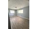 Bedroom with two windows providing natural light, ceiling fan, and light gray walls at 763 N Hairston Rd, Stone Mountain, GA 30083