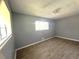 Bedroom featuring wood-look flooring, a ceiling fan, and two windows for natural light at 763 N Hairston Rd, Stone Mountain, GA 30083