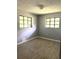 Bright bedroom featuring modern gray walls, and wood-look vinyl flooring at 763 N Hairston Rd, Stone Mountain, GA 30083