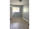 Bright bedroom featuring modern gray walls, and wood-look vinyl flooring at 763 N Hairston Rd, Stone Mountain, GA 30083