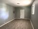 Bright living room featuring modern gray walls and wood-look vinyl flooring at 763 N Hairston Rd, Stone Mountain, GA 30083