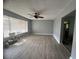 Living room featuring wood-look flooring, natural light, a ceiling fan, and grey walls at 763 N Hairston Rd, Stone Mountain, GA 30083