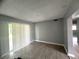 Cozy living room featuring neutral gray walls and wood-look vinyl flooring at 763 N Hairston Rd, Stone Mountain, GA 30083
