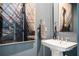 Stylish powder room featuring a pedestal sink, modern art, and unique decor at 1762 Beckham Ne Pl, Atlanta, GA 30324