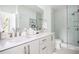 Modern bathroom with double sinks, white cabinets, and glass-enclosed shower at 1762 Beckham Ne Pl, Atlanta, GA 30324