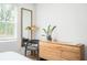 Bedroom featuring a modern wood dresser, mirror, and leafy potted plant at 1762 Beckham Ne Pl, Atlanta, GA 30324