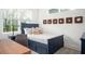 Cozy bedroom with a blue bedframe, patterned pillows, and unique wooden wall art at 1762 Beckham Ne Pl, Atlanta, GA 30324