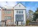 Charming multi-story townhouse with a combination of brick and light gray siding and fenced yard at 1762 Beckham Ne Pl, Atlanta, GA 30324