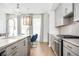 Bright kitchen with stainless steel appliances, light wood floors, and gray cabinets at 1762 Beckham Ne Pl, Atlanta, GA 30324