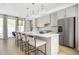Bright, open kitchen with an island, sleek cabinets, modern lighting, and stainless steel appliances at 1762 Beckham Ne Pl, Atlanta, GA 30324