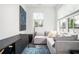 Comfortable living room featuring a sectional sofa, large windows, and stylish decor at 1762 Beckham Ne Pl, Atlanta, GA 30324