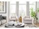 Cozy living room features two plush chairs, a round marble coffee table, and large windows for natural light at 1762 Beckham Ne Pl, Atlanta, GA 30324