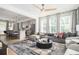 Open-concept living room featuring a large sofa, modern lighting, and seamless flow to the kitchen at 1762 Beckham Ne Pl, Atlanta, GA 30324
