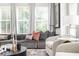 Bright living room features a comfortable sectional sofa, plush chairs, and natural light from large windows at 1762 Beckham Ne Pl, Atlanta, GA 30324