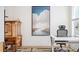 Bright office with modern desk, ornate cabinet and rug, and a large painting with a river scene at 1762 Beckham Ne Pl, Atlanta, GA 30324