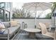 Outdoor patio area with modern furniture, an umbrella, and a cozy seating arrangement at 1762 Beckham Ne Pl, Atlanta, GA 30324