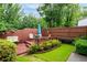 Backyard featuring a wooden deck, seating, and a well-maintained lawn with lush greenery at 1926 Cheatham Woods Sw Dr, Marietta, GA 30008