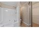 Bright bathroom featuring a soaking tub with white enclosure and a closet with wire shelving at 1926 Cheatham Woods Sw Dr, Marietta, GA 30008