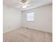 Minimalist bedroom with neutral carpet, ceiling fan, and a window providing natural light at 1926 Cheatham Woods Sw Dr, Marietta, GA 30008