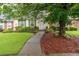 Charming home with a well-manicured lawn and garden beds, enhancing curb appeal at 1926 Cheatham Woods Sw Dr, Marietta, GA 30008