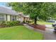 Home exterior with a well-maintained lawn, mature trees, and tasteful landscaping at 1926 Cheatham Woods Sw Dr, Marietta, GA 30008
