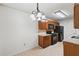 Well-lit kitchen offers ample storage with wooden cabinets and granite countertops at 1926 Cheatham Woods Sw Dr, Marietta, GA 30008