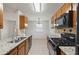 Eat-in kitchen features granite countertops, wood cabinets, and stainless steel sink at 1926 Cheatham Woods Sw Dr, Marietta, GA 30008