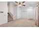 Bright living room with staircase, closet, and doorway, offers neutral carpeting and natural lighting at 1926 Cheatham Woods Sw Dr, Marietta, GA 30008