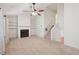 Bright living room boasts a fireplace, built-in shelving, neutral carpet, and staircase to upper level at 1926 Cheatham Woods Sw Dr, Marietta, GA 30008