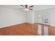 An airy living room has hardwood floors, glass doors leading to the outside, and natural light at 1926 Cheatham Woods Sw Dr, Marietta, GA 30008