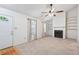 Spacious living room with ample natural light, a fireplace, built-in shelving, and neutral carpeting at 1926 Cheatham Woods Sw Dr, Marietta, GA 30008