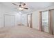 Open living room featuring neutral carpeting, a vaulted ceiling, and large windows with decorative curtains at 1926 Cheatham Woods Sw Dr, Marietta, GA 30008