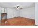 Bedroom featuring hardwood floors, closet with bi-fold doors and staircase to upper level at 1926 Cheatham Woods Sw Dr, Marietta, GA 30008